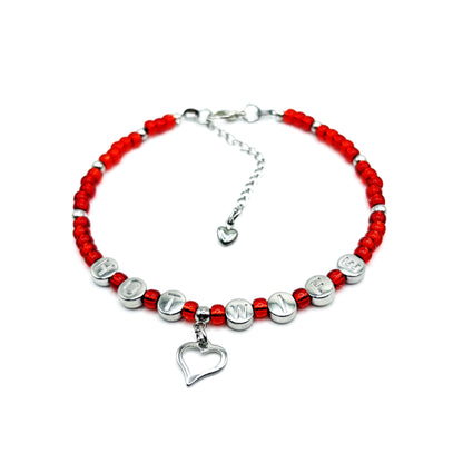 Bracelet with red beads and silver charms on a white background